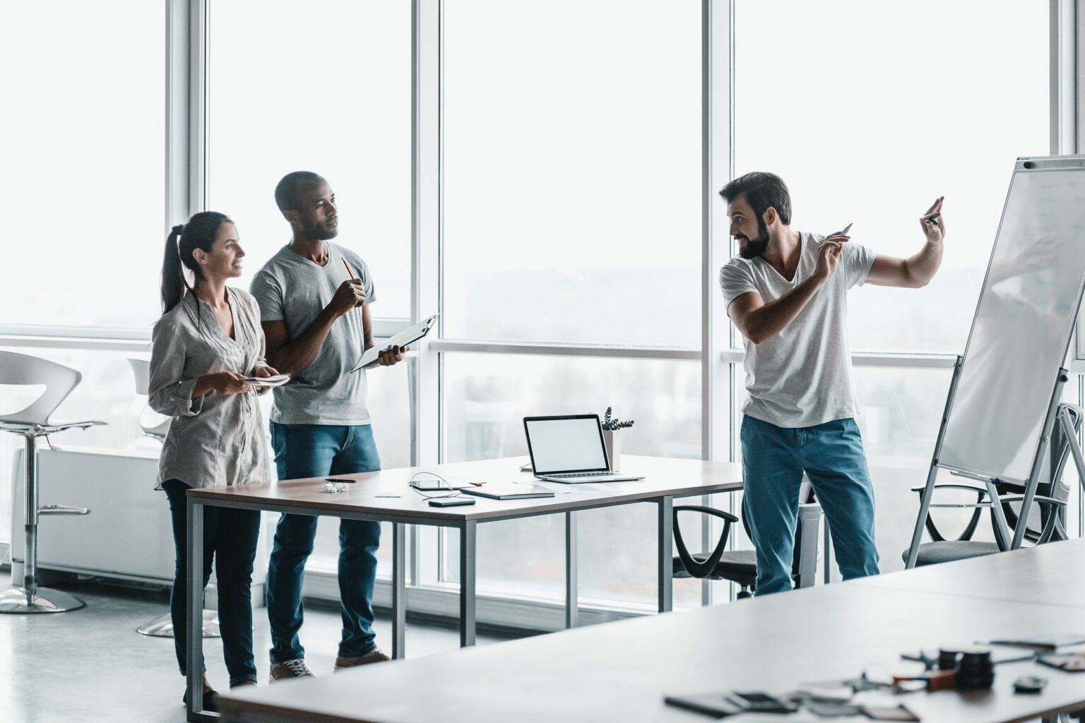 Team of three co-workers in stylish studio