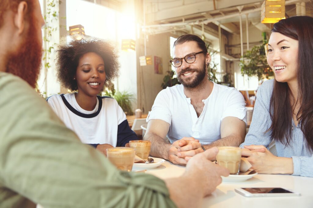 friendship and communication concept four young people of diverse ethnicities or cultures dressed c.jpg